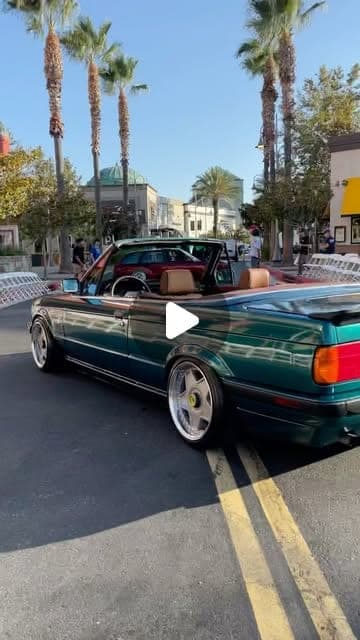 Green BMW E30 convertible at a car show, from a reel