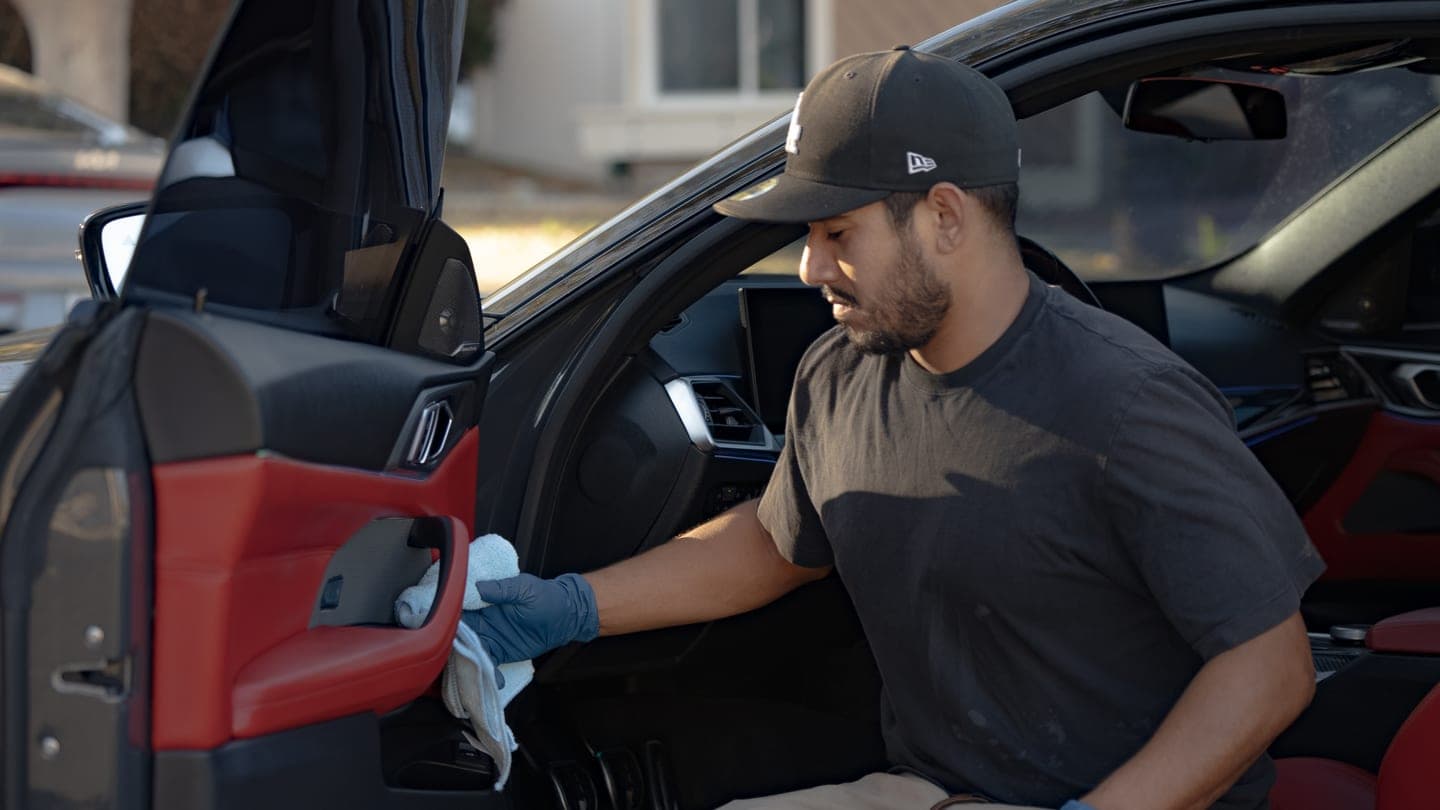 Nick cleaning the driver's door card of the M4