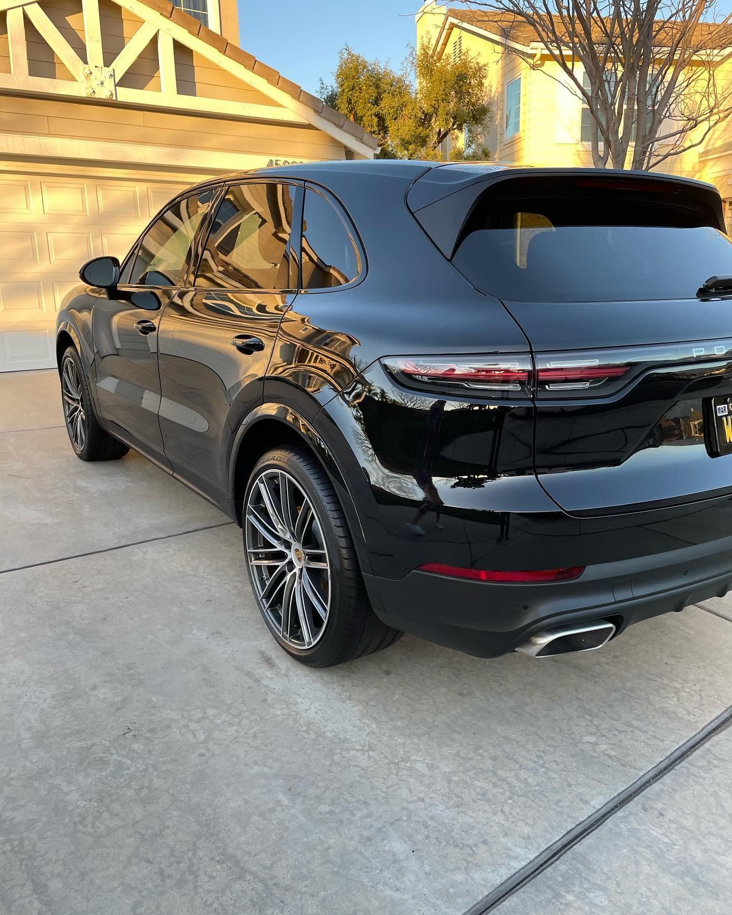 Black Porsche Cayenne on a Temecula driveway after a paint correction