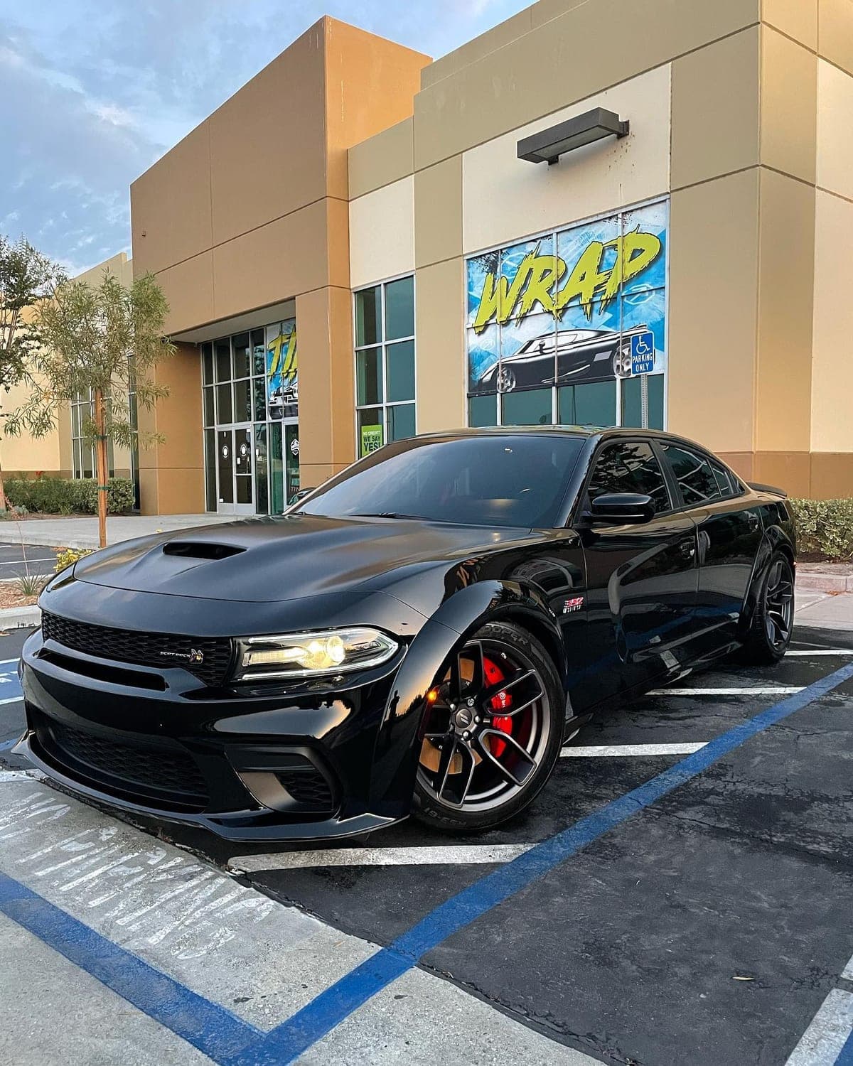 Black Dodge Charger, front three-quarter, after detailing